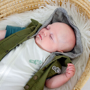 Childrens fashion photography for Kauri and Sons sleeping babby in moses basket