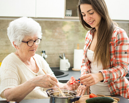 image showing older lady and granddaughter preparing nutritional meal together