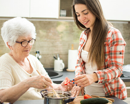 image showing older lady and granddaughter preparing nutritional meal together