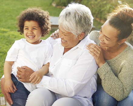 image showing grandson, mother and grandmother laughing in a park