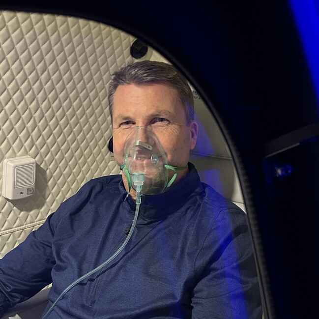 Client undergoing hyperbaric oxygen therapy for recovery support