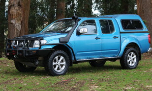 2009 Nissan Navara Featuring an ARB Deluxe Bar, KingOne Raptor Winch, ARB Side Rails & Steps, OME Suspension Lift, Safari Snorkel, ARB Under Vehicle Protection Plate & Mickey Thompson ATZ P3 Tyres