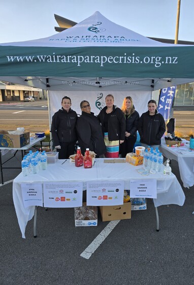 Wairarapa Rape and Sexual Abuse Collective Inc. team at 2025 Rape awareness week hosting a sausage sizzle in a branded tent