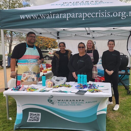 Wairarapa Rape and Sexual Abuse Collective Inc. team at 2024 Rape awareness week hosting a sausage sizzle in a branded tent