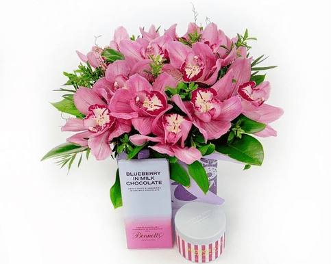 Elegant orchid gift box featuring fresh flowers and carefully selected delights