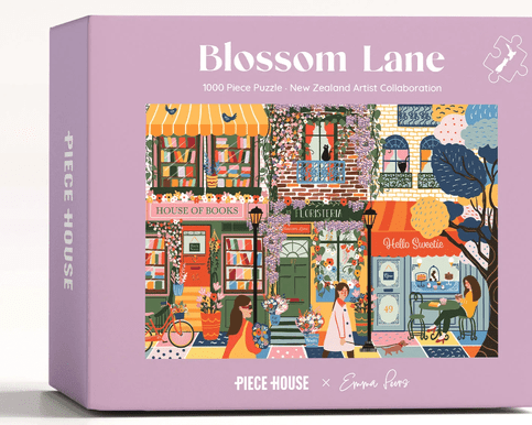 Blossom Lane 1000 Piece Jigsaw Puzzle – beautifully illustrated floral lane scene with vibrant blossoms and intricate details, perfect for puzzle lovers, relaxation, and gifting.