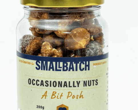 Occasionally Nuts – A Bit Posh gourmet nut mix in a clear pouch with golden accents, featuring a blend of premium roasted nuts and a hint of sweetness — a perfect artisan treat to complement floral and gift boxes from Flowers by Joanne.