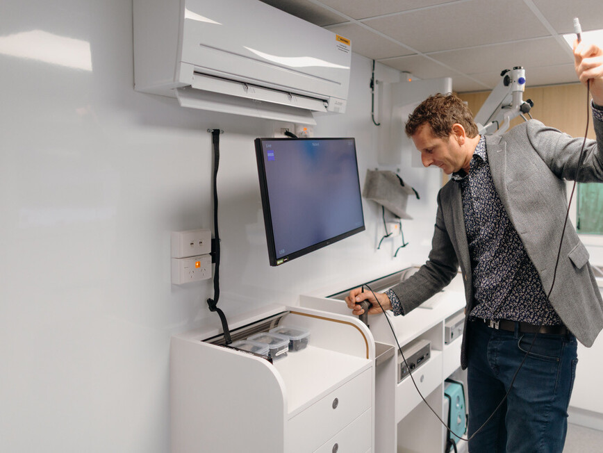 Dr David Waterhouse Leaning on the Tarapunga Mobile ENT clinic Van