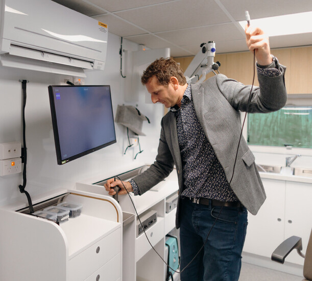 Dr David Waterhouse Leaning on the Tarapunga Mobile ENT clinic Van