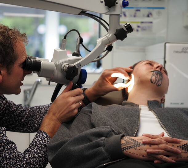 Dr David Waterhouse Examining a patient with an ENT microscope