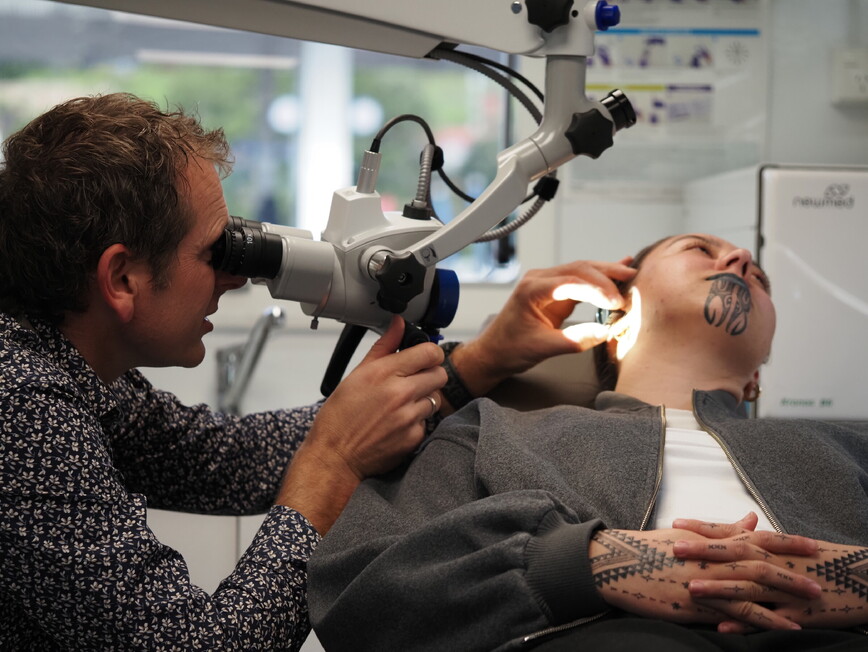 Dr David Waterhouse Examining a patient with an ENT microscope