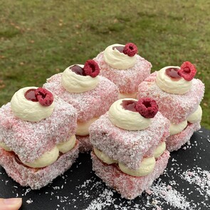 Photo of gluten free chocolate slice with pink icing and gold leaf