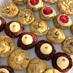 Photo of shiny chocolate icing cookies with caramel squiggly icing