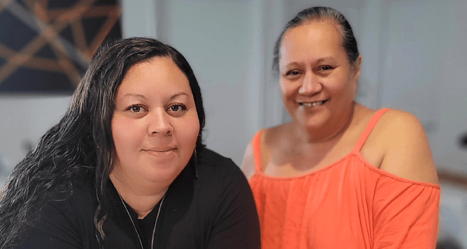 Reina (right) stands with a wahine being supported in 155's transitional home.