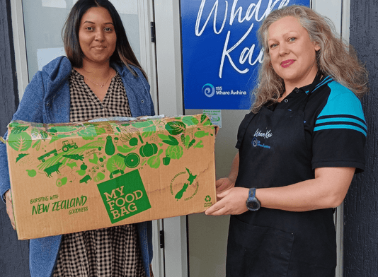Kaihautū Whare Kai Daniela Johnson receives a donation from Kamo High School.