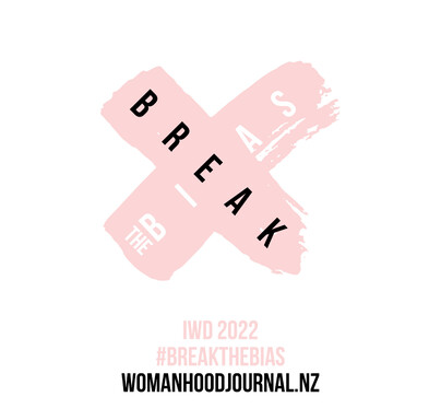 Pink cross with the words 'break the bias' enclosed, the theme for the 2022 International Women's Day