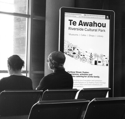 Advertising on a screen at Palmerston North airport for Te Awahou Roverside Cultural Park