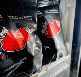 Lewis Farms frozen strawberries packaging in a fridge