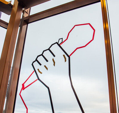 Tape Art on the window of a hand holding a microphone