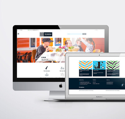 Mac and laptop with Te Awahou website open