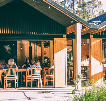 People conversing in the wharenui at Arete