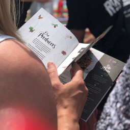 Woman browsing a Taste Trail brochure