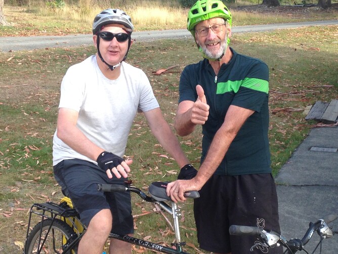 Two visually impaired travellers standing beside their tandem bikes during the Alps 2 Ocean accessible cycling tour in New Zealand.