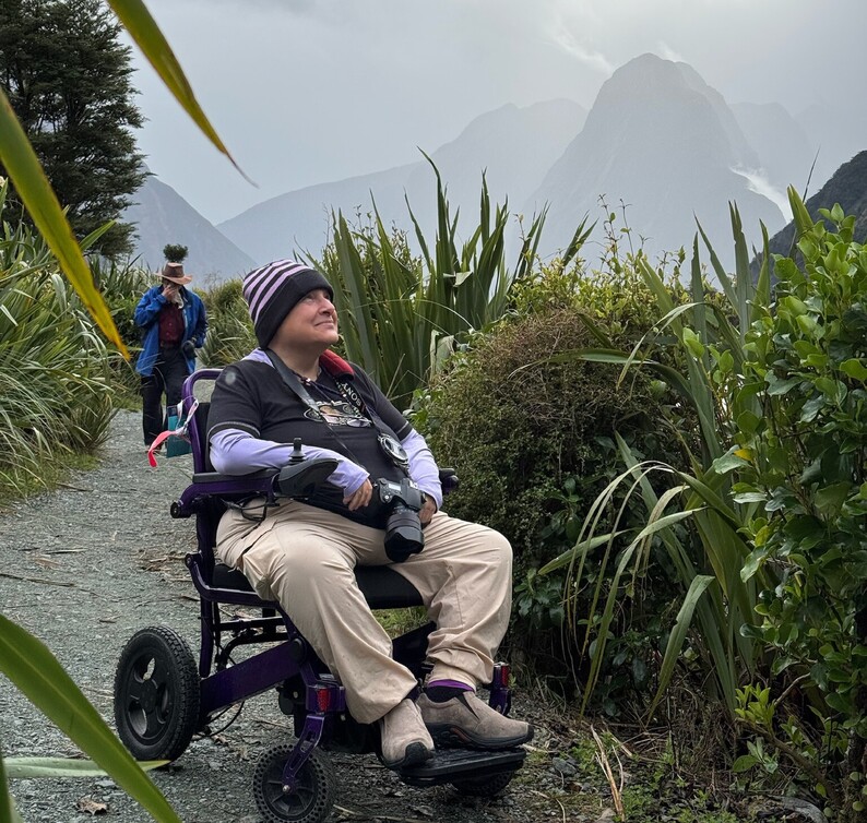 Man in a wheelchair enjoying a scenic path along one of New Zealand's stunning Sounds