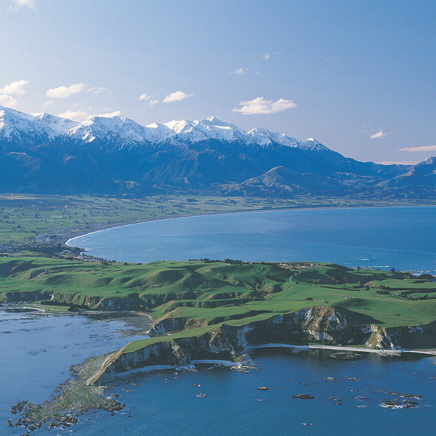 Drone view of Kaikōura coastline with the Southern Alps in the background