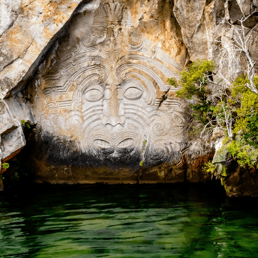 Māori rock carvings on Lake Taupō with calm water