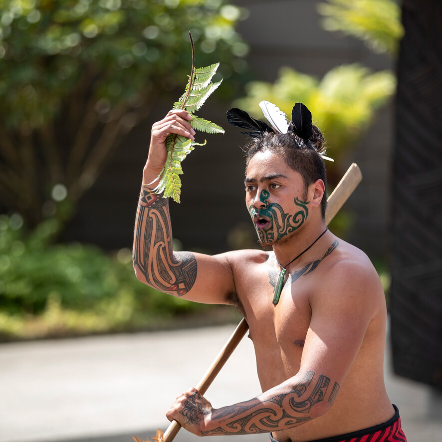 Māori warrior performing a welcoming pōwhiri ceremony