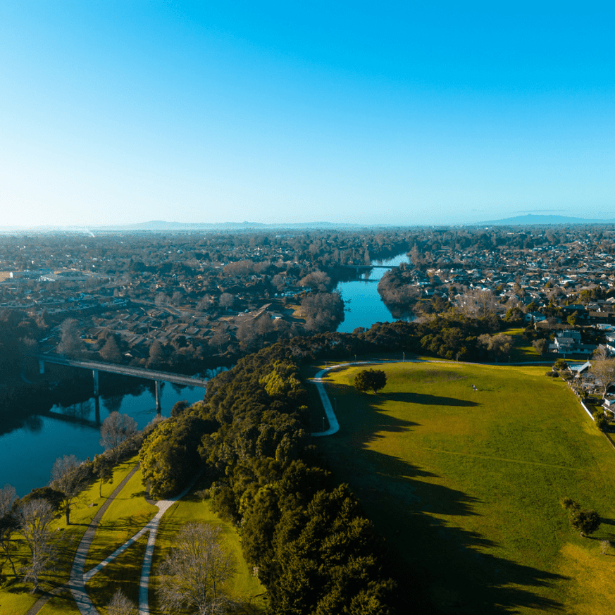 Drone shot showing the Waikato River winding through Hamilton city
