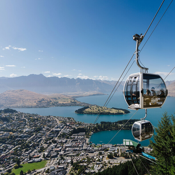 Gondola ride ascending Queenstown with lake and mountains view