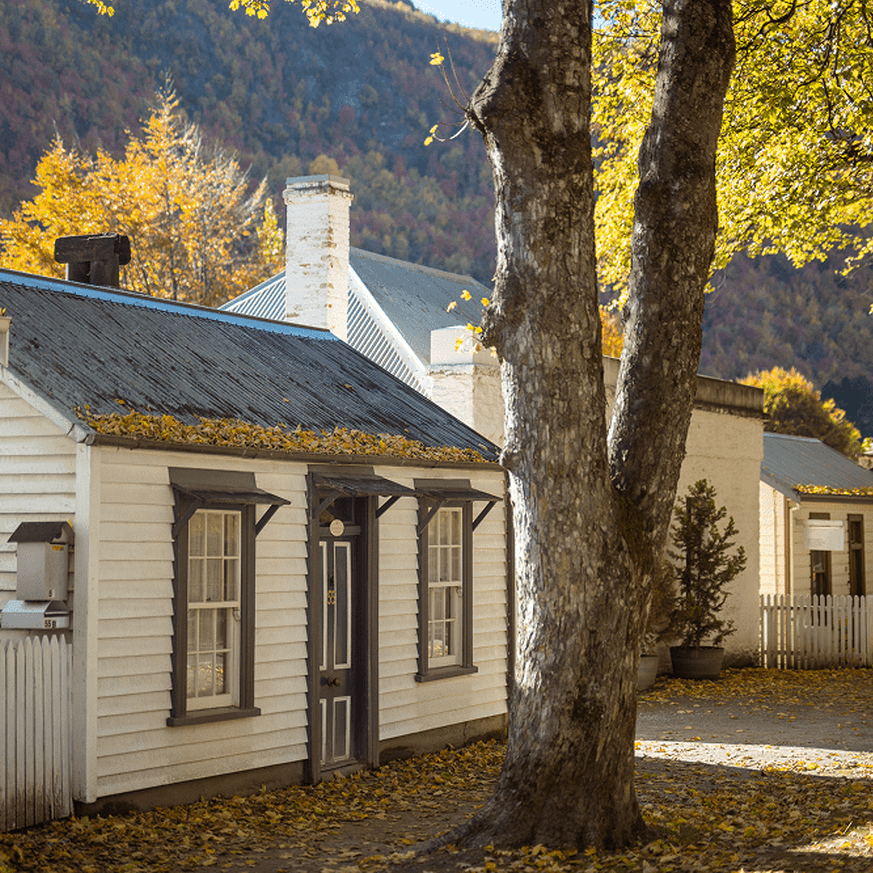 House in Arrowtown surrounded by autumn foliage