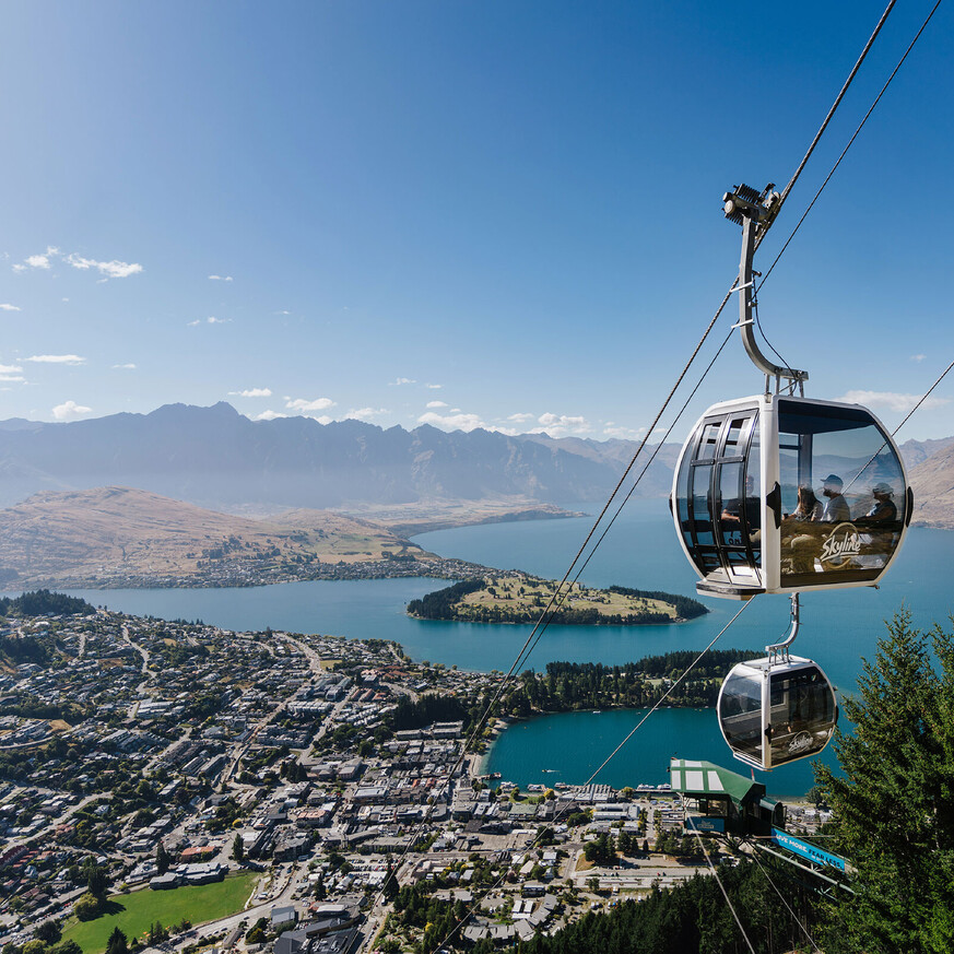 Gondola ride ascending Queenstown with lake and mountains view