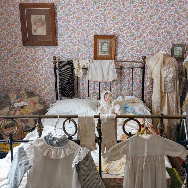 Child's bedroom showing Victorian clothing and furnishings in Martinborough Museum