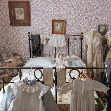 Child's bedroom showing Victorian clothing and furnishings in Martinborough Museum