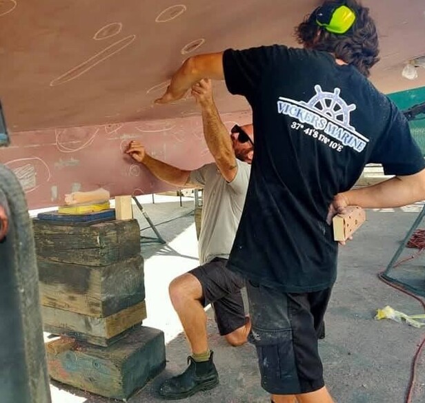 Vickers Marine working on the bottom of a boat