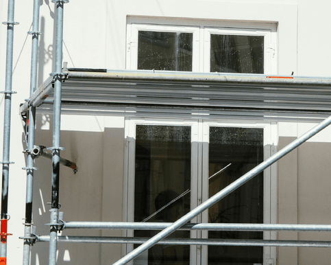 Scaffolding outside a building being painted.