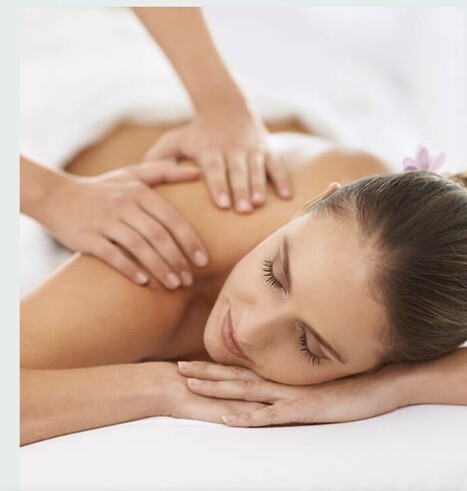 Picture of a lady lying on a massage bed having a back massage.