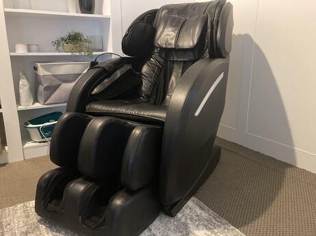 Picture of a Relax Sign on a table with red candles light behind