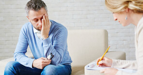 Man in suit looking stressed