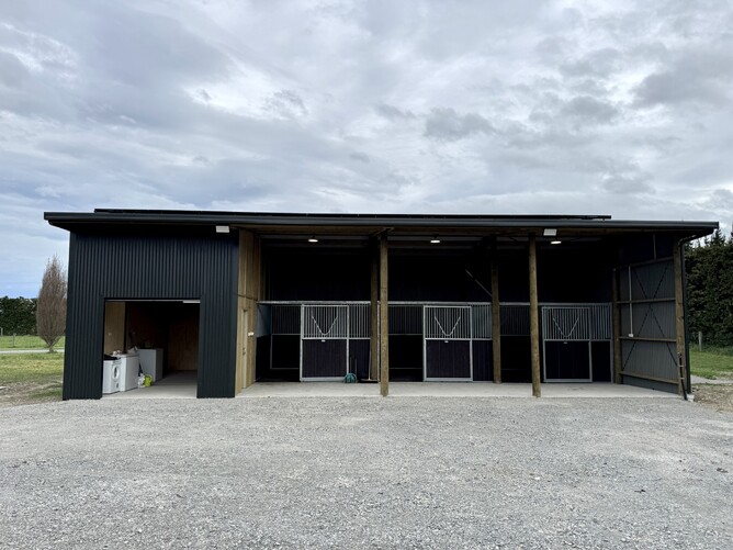 completed 4 bay pole shed with tack room horse stables and concrete floor