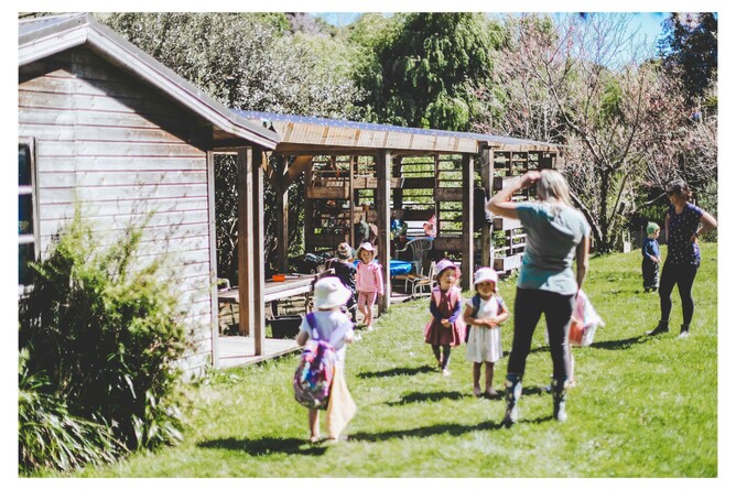 Teacher and children exploring the outdoor nature space at our early childhood centre in Welcome Bay.