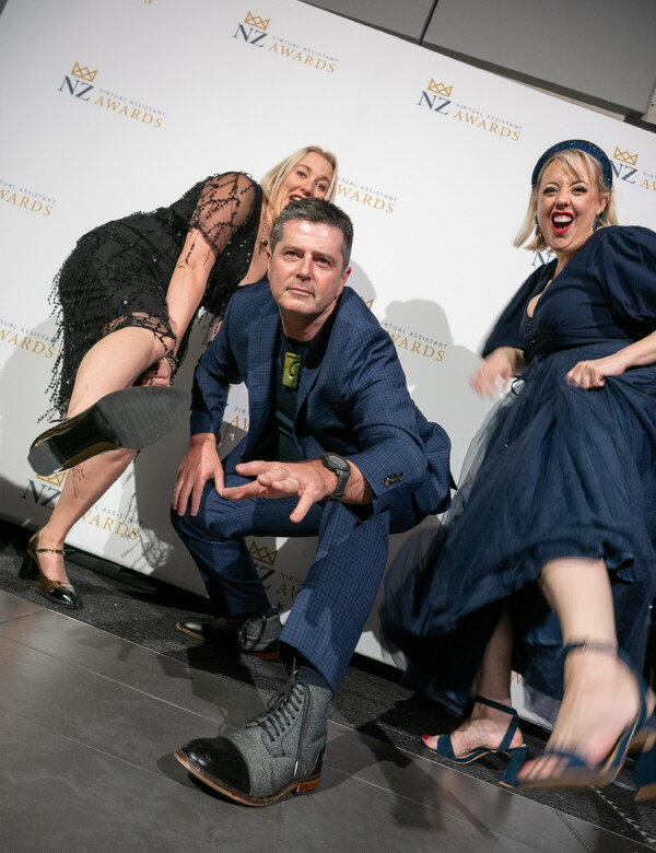 Event guests posing in front of the media wall at the NZ Virtual Assistant Awards in Hamilton, New Zealand.