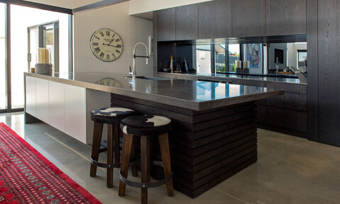 Polished concrete floors complementing the industrial design, with custom joinery by Barrett Joinery.