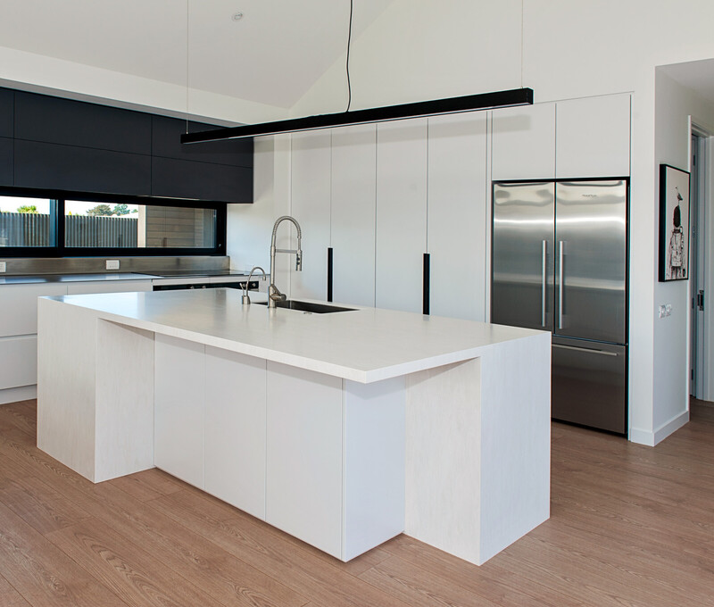 Sleek minimalist kitchen design with clean lines and custom cabinetry, crafted by Barrett Joinery in Timaru.