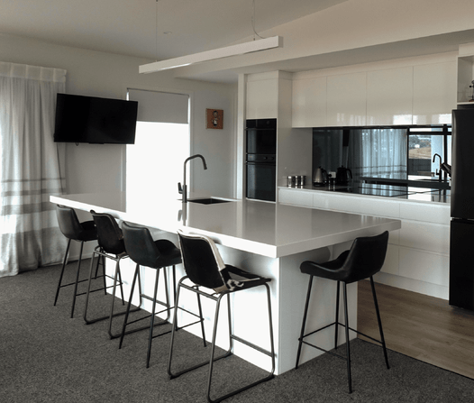 Sophisticated black and white kitchen with custom joinery, perfect for contemporary homes in Central Otago.