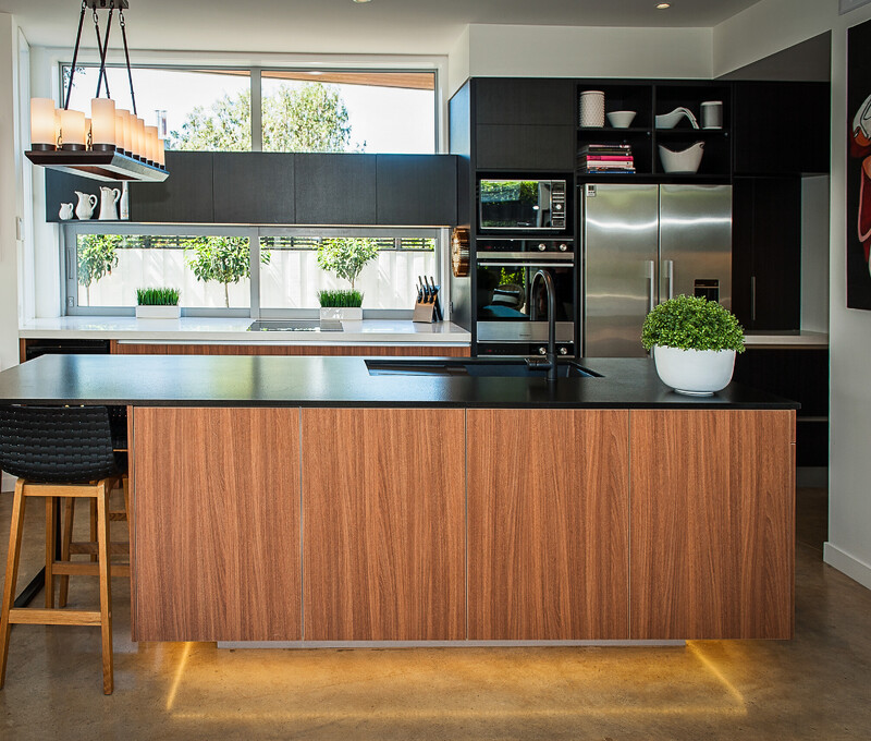 Spacious modern family kitchen with a large island and integrated appliances, showcasing kitchen design by Barrett Joinery.