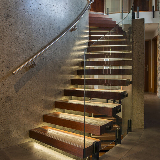 Custom-built staircases with precision craftsmanship, including straight and curved designs by Barrett Joinery.